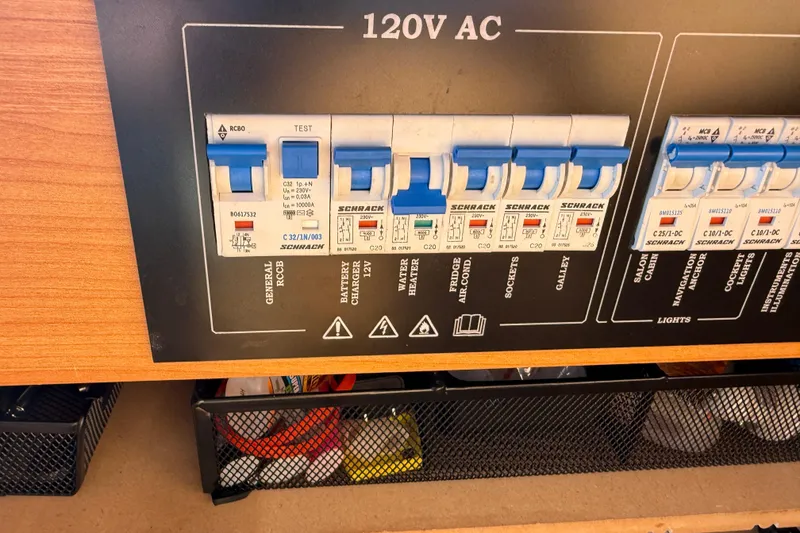 Slide: The Image of 2013 Greenline 33 electrical panel with circuit breakers and 120V AC labels. - 63
