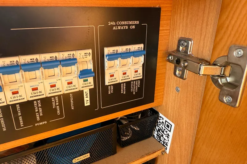 Slide: The Image of Electrical panel inside a 2013 Greenline 33 boat, featuring circuit breakers and labels. - 65