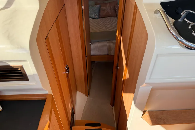 Slide: The Image of Interior view of 2013 Greenline 33 yacht, featuring wooden cabinetry and cozy sleeping area. - 67