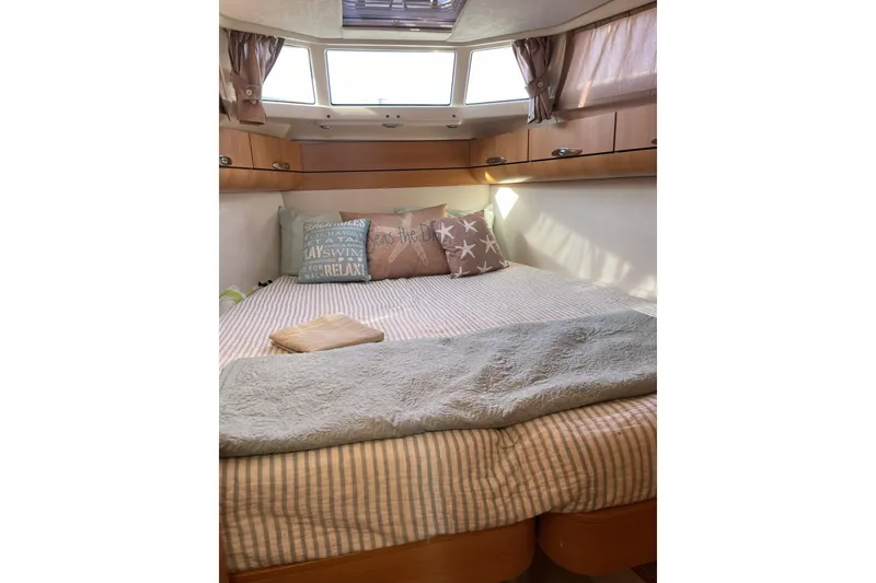 Slide: The Image of Cozy cabin interior of 2013 Greenline 33 yacht with comfortable bedding and decorative pillows. - 72