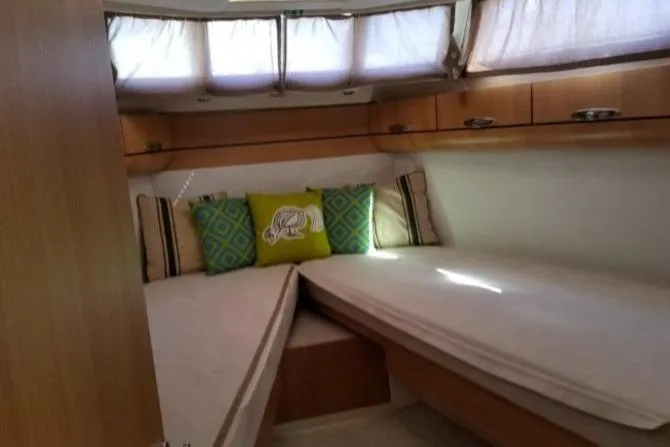 Slide: The Image of Cozy cabin interior of 2013 Greenline 33 yacht with decorative pillows and natural light. - 73