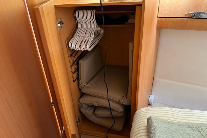 Slide: The Image of Cabinet interior on 2013 Greenline 33 boat with hangers and folded cushions. - 75