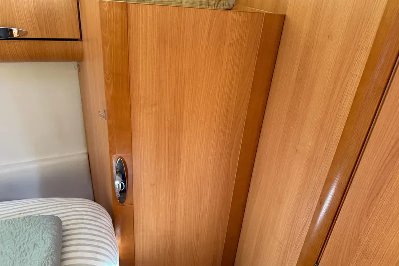 Slide: The Image of Interior of 2013 Greenline 33 boat with wooden cabinetry and bedding. - 76