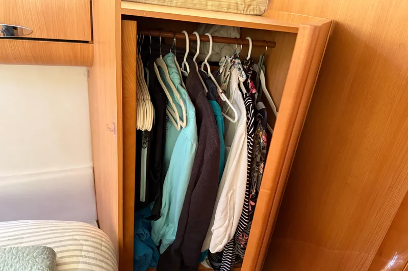 Slide: The Image of Wardrobe inside 2013 Greenline 33 boat with clothes on hangers. - 77