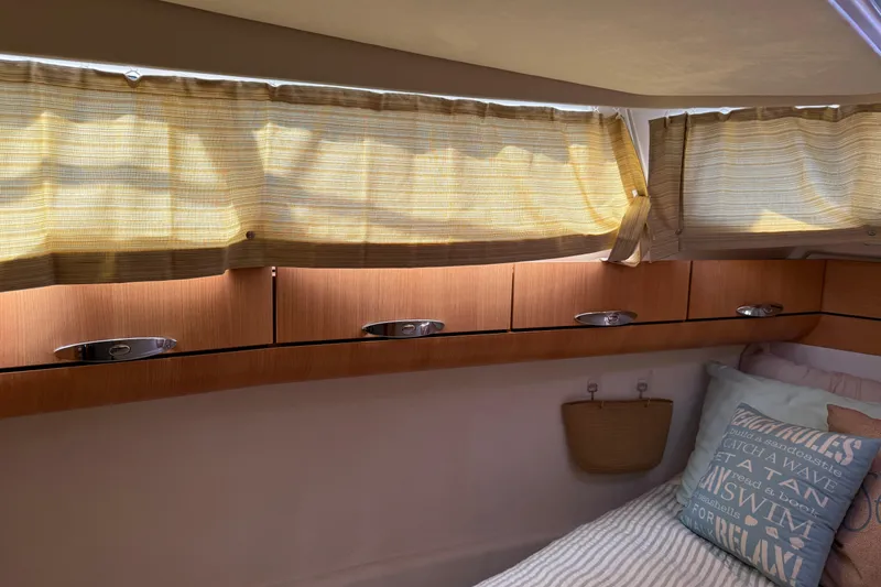 Slide: The Image of Cozy cabin interior of 2013 Greenline 33 yacht with wooden cabinets and soft lighting. - 79