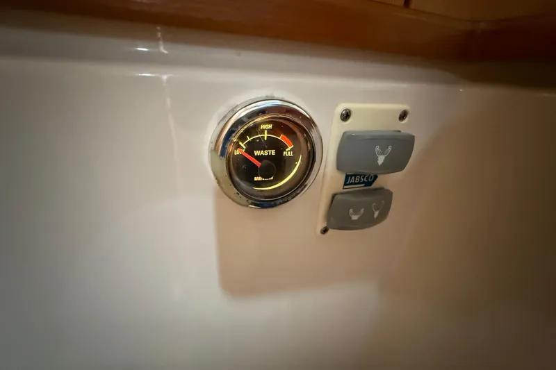 Slide: The Image of Waste level gauge and Jabsco controls on 2013 Greenline 33 boat interior. - 85