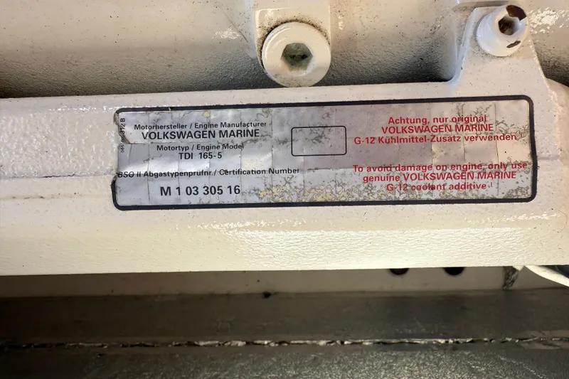Slide: The Image of Volkswagen Marine engine label on 2013 Greenline 33, specifying TDI 165-5 model and coolant instructions. - 89