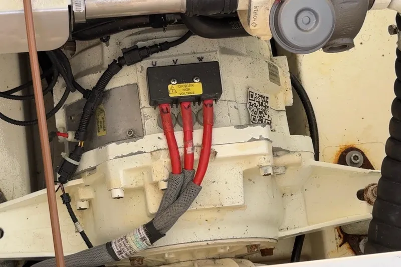 Slide: The Image of Engine compartment of a 2013 Greenline 33 with visible wiring and high voltage warning. - 91