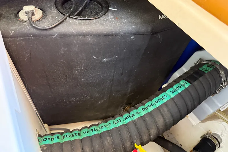 Slide: The Image of Engine compartment of a 2013 Greenline 33 boat with visible hoses and wiring. - 94