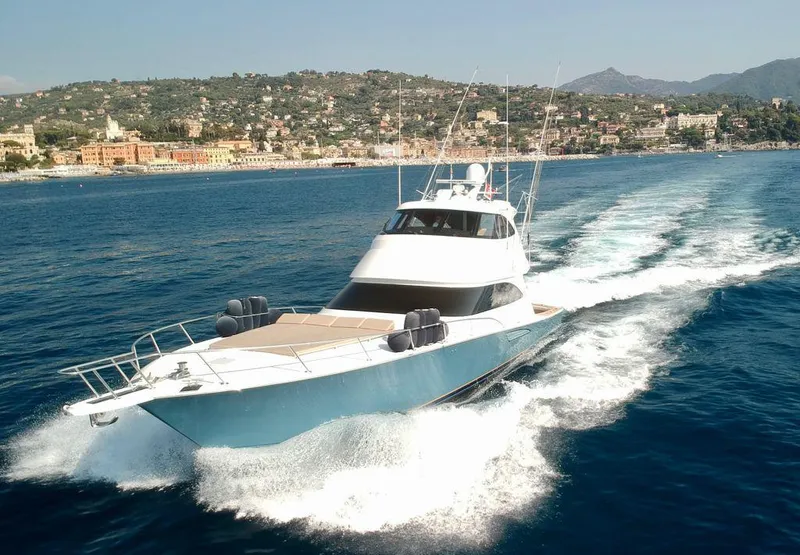 Slide: The Image of 2018 Viking 62 Enclosed Bridge yacht cruising on blue ocean near scenic coastline. - 11