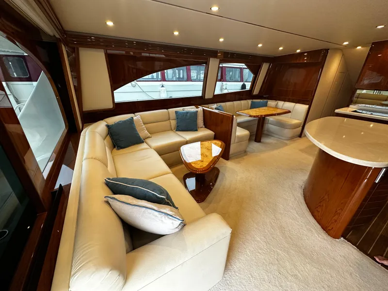Slide: The Image of Luxurious interior of 2018 Viking 62 Enclosed Bridge yacht with plush seating and elegant decor. - 17