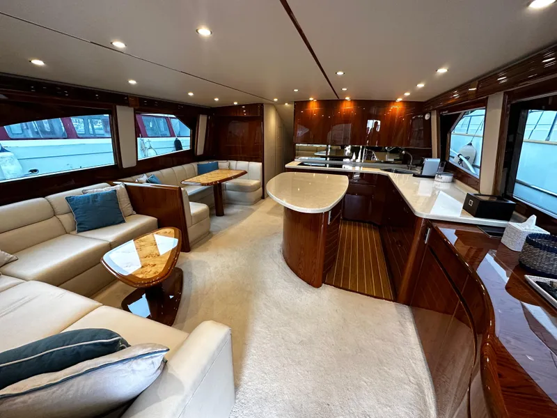 Slide: The Image of Luxurious interior of 2018 Viking 62 Enclosed Bridge yacht with elegant seating and modern kitchen. - 18