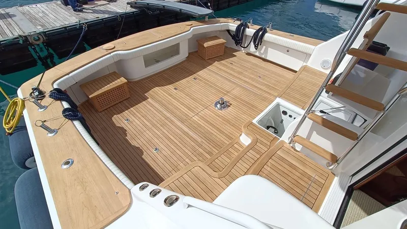 Slide: The Image of 2018 Viking 62 Enclosed Bridge yacht with spacious teak deck and docked at marina. - 3