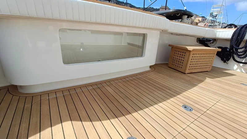 Slide: The Image of 2018 Viking 62 Enclosed Bridge yacht deck with teak flooring and storage box. - 30