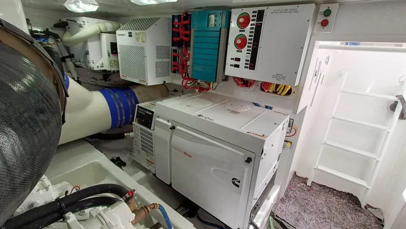 Slide: The Image of Engine room of 2018 Viking 62 Enclosed Bridge yacht, featuring electrical systems and equipment. - 34