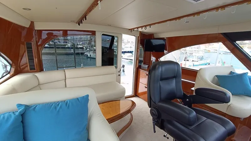 Slide: The Image of Luxurious interior of 2018 Viking 62 Enclosed Bridge yacht with leather seating and ocean view. - 39