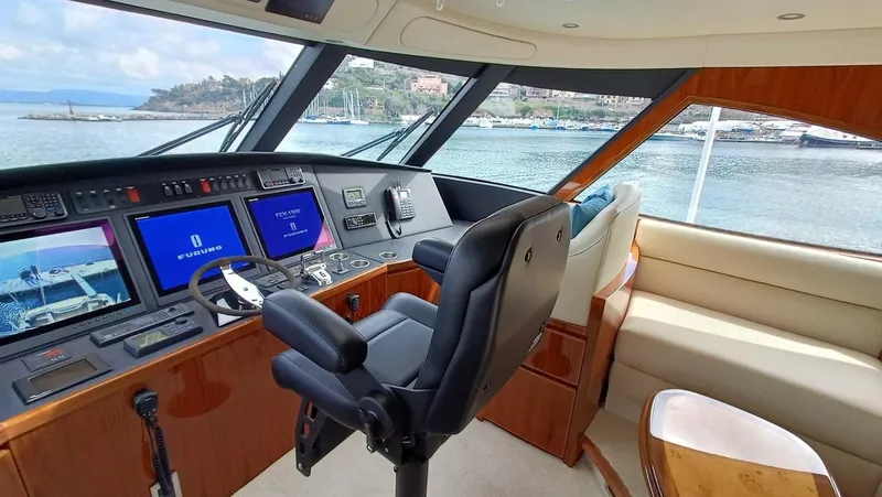 Slide: The Image of 2018 Viking 62 Enclosed Bridge helm with navigation screens and luxurious seating. - 41