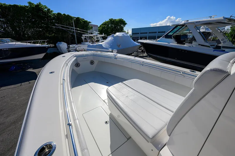 Slide: The Image of 2021 Contender 35 ST boat with spacious seating, docked under clear blue sky. - 11