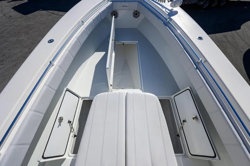 Slide: The Image of 2021 Contender 35 ST boat interior with open storage compartments and cushioned seating. - 12