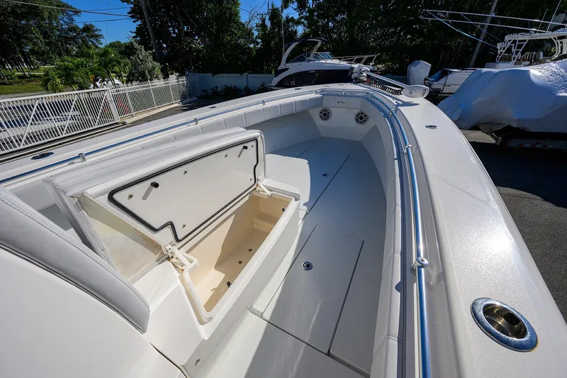 Slide: The Image of 2021 Contender 35 ST boat with open storage compartment, sleek white deck, and stainless steel railings. - 13