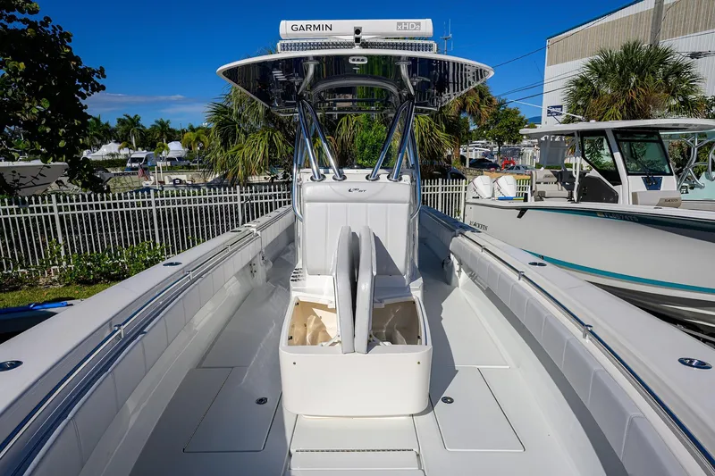 Slide: The Image of 2021 Contender 35 ST boat with open storage, sleek design, and Garmin equipment. - 15
