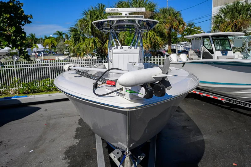 Slide: The Image of 2021 Contender 35 ST boat with Garmin equipment, parked outdoors near palm trees. - 2