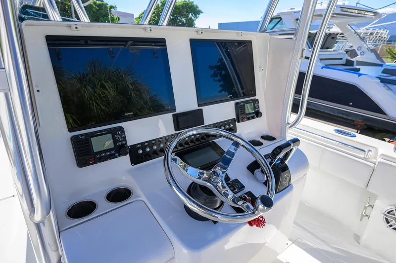 Slide: The Image of 2021 Contender 35 ST boat dashboard with dual screens and steering wheel. - 21