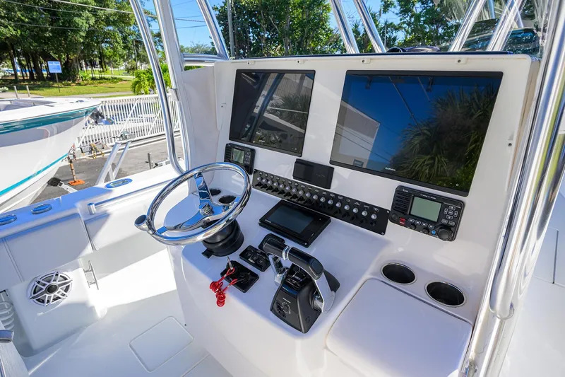 Slide: The Image of 2021 Contender 35 ST boat dashboard with dual screens and steering wheel. - 22