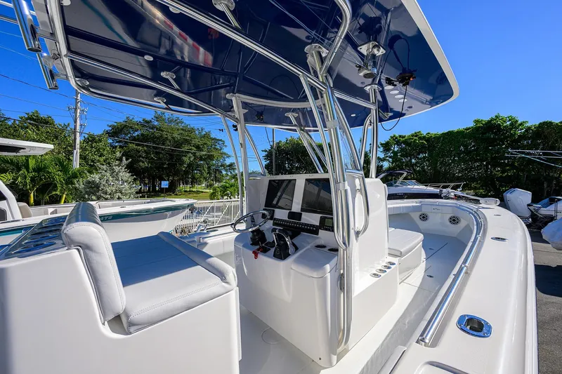 Slide: The Image of 2021 Contender 35 ST boat cockpit with modern controls and seating under a blue canopy. - 23