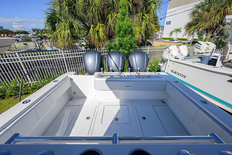 Slide: The Image of 2021 Contender 35 ST boat with triple outboard engines, spacious deck, and sleek design. - 26