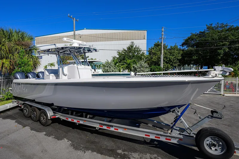 Slide: The Image of 2021 Contender 35 ST boat on trailer, parked outdoors under clear blue sky. - 3