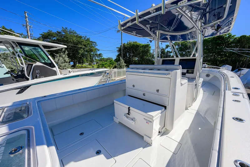 Slide: The Image of 2021 Contender 35 ST boat interior with seating and storage, under a clear blue sky. - 32
