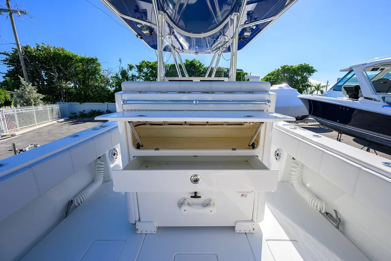 Slide: The Image of 2021 Contender 35 ST boat interior with open storage compartment, showcasing sleek design. - 33
