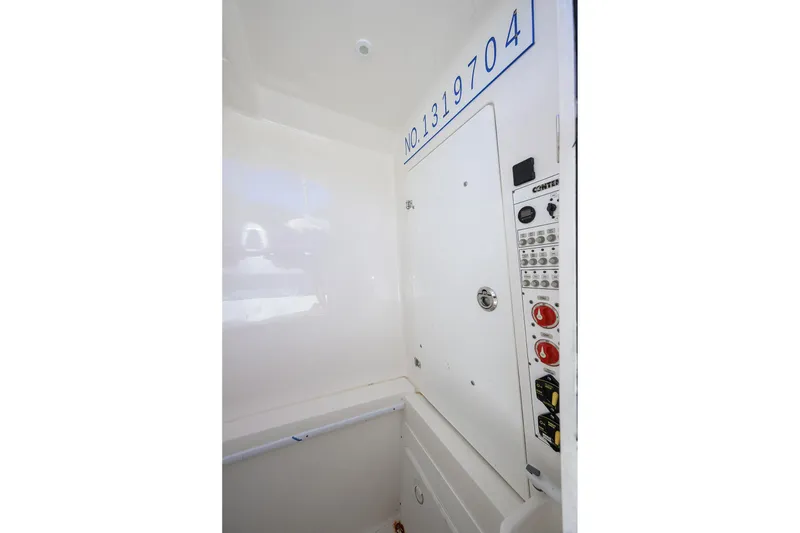 Slide: The Image of 2021 Contender 35 ST boat interior control panel with registration number. - 38