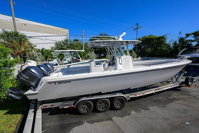 Slide: The Image of 2021 Contender 35 ST boat on trailer with Yamaha engines, parked outdoors. - 4