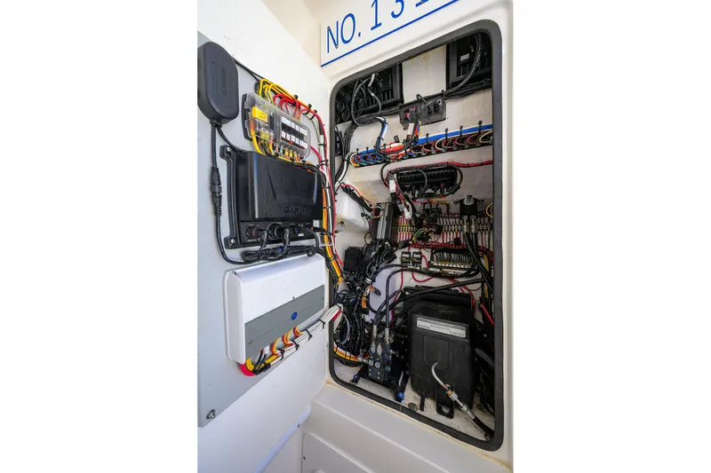 Slide: The Image of Electrical panel of a 2021 Contender 35 ST boat, showcasing wiring and components. - 40