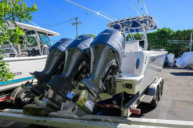 Slide: The Image of 2021 Contender 35 ST boat with triple Yamaha outboard engines on a trailer. - 44