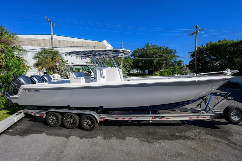 Slide: The Image of 2021 Contender 35 ST boat on trailer, parked outdoors under clear blue sky. - 5