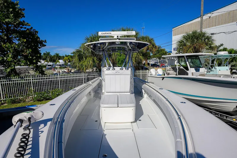 Slide: The Image of 2021 Contender 35 ST boat with sleek design, docked outdoors under clear blue sky. - 6