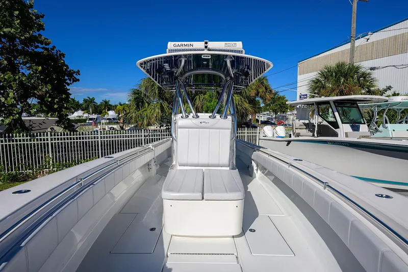 Slide: The Image of 2021 Contender 35 ST boat with sleek design, white seating, and advanced Garmin navigation. - 7