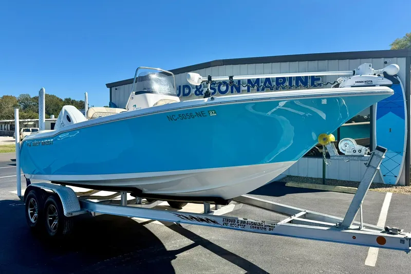 The Image of 2025 Key West 203 FS boat on trailer, displayed at a marine dealership. - 1