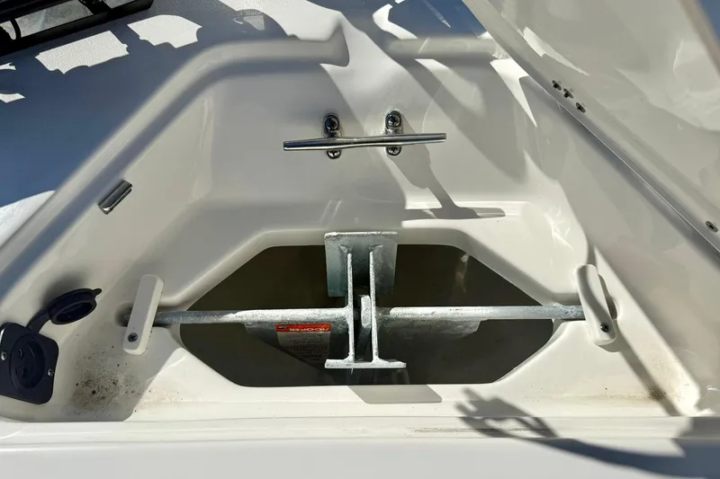 Slide: The Image of Anchor storage compartment in 2025 Key West 203 FS boat, featuring secure metal fittings. - 17
