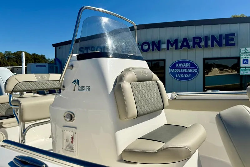 Slide: The Image of 2025 Key West 203 FS boat interior with seating, displayed at a marine dealership. - 20