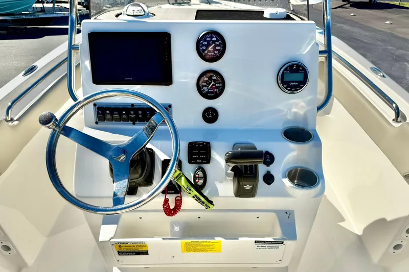Slide: The Image of 2025 Key West 203 FS boat dashboard with steering wheel and navigation instruments. - 3