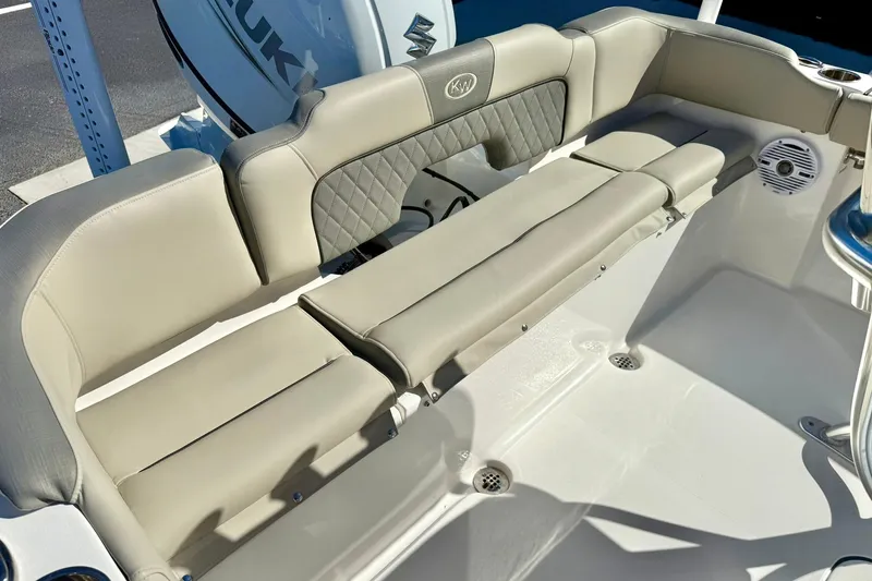 Slide: The Image of 2025 Key West 203 FS boat interior with beige seating and Suzuki engine. - 31