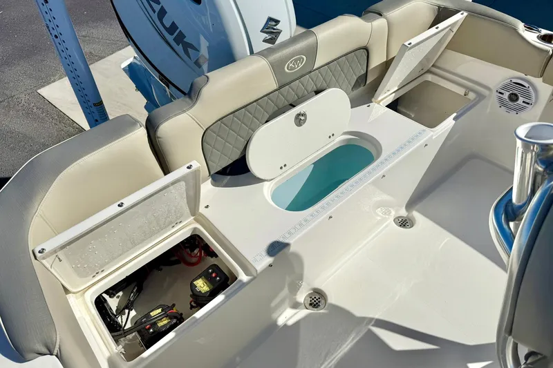 Slide: The Image of 2025 Key West 203 FS boat interior with storage compartments and Suzuki engine. - 33