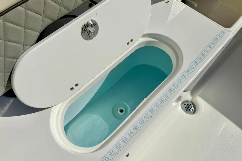 Slide: The Image of 2025 Key West 203 FS boat livewell with open lid and measurement scale. - 35