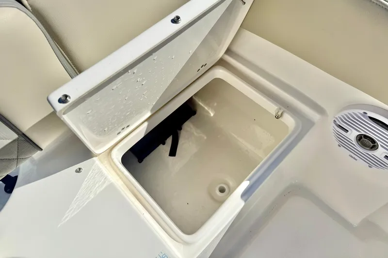 Slide: The Image of Open storage compartment on 2025 Key West 203 FS boat, with visible speaker nearby. - 36