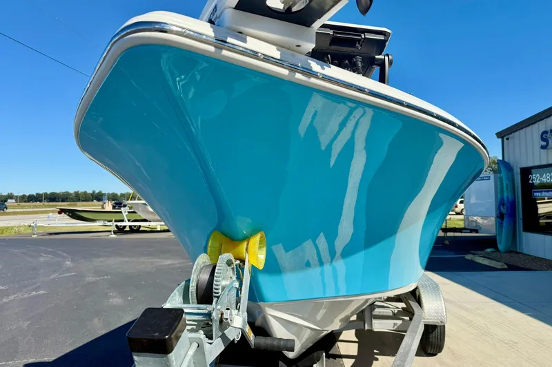 Slide: The Image of 2025 Key West 203 FS boat on trailer, vibrant blue hull, outdoor display. - 8