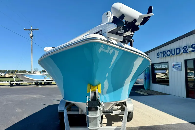 Slide: The Image of 2025 Key West 203 FS boat on trailer outside dealership under clear blue sky. - 9